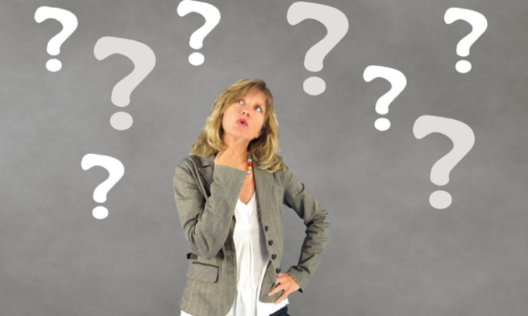 woman surrounded by question marks wondering if you can get cavites with dental sealants