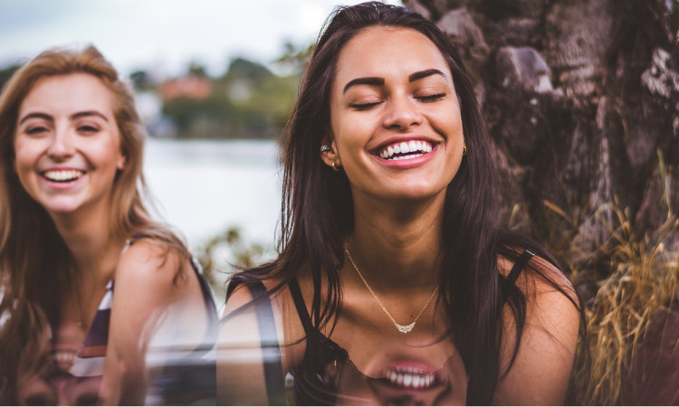 two girls smiling with big white smiles