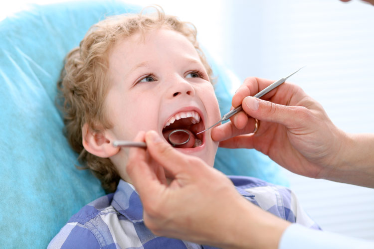 young boy at the dentist getting an oral exam