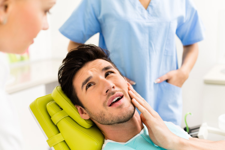 man in the dental chair after root canal therapy