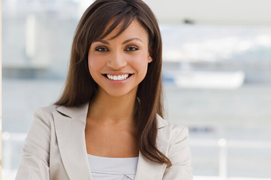 young woman smiles after receiving a one-visit crown at the dentist