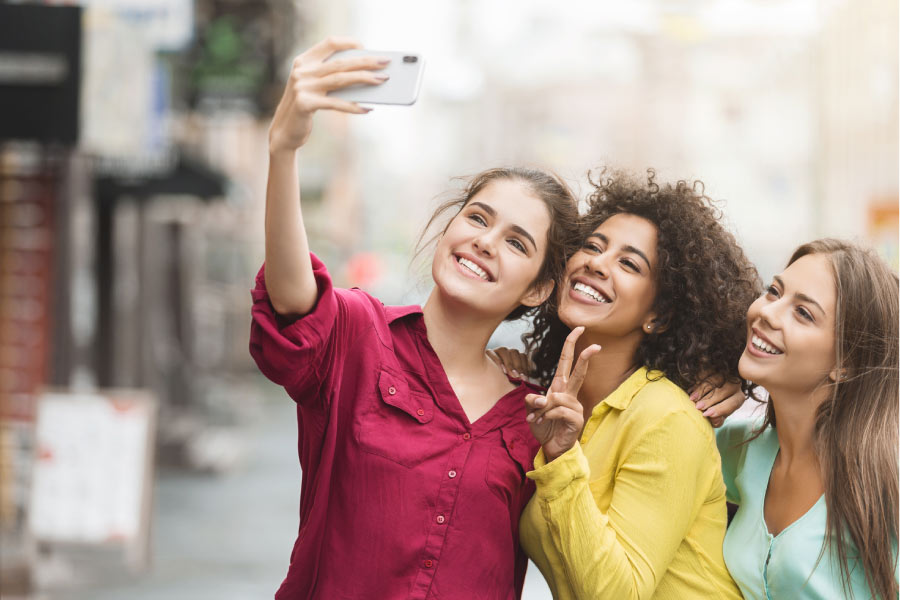 three young women take a break from college to take a selfie