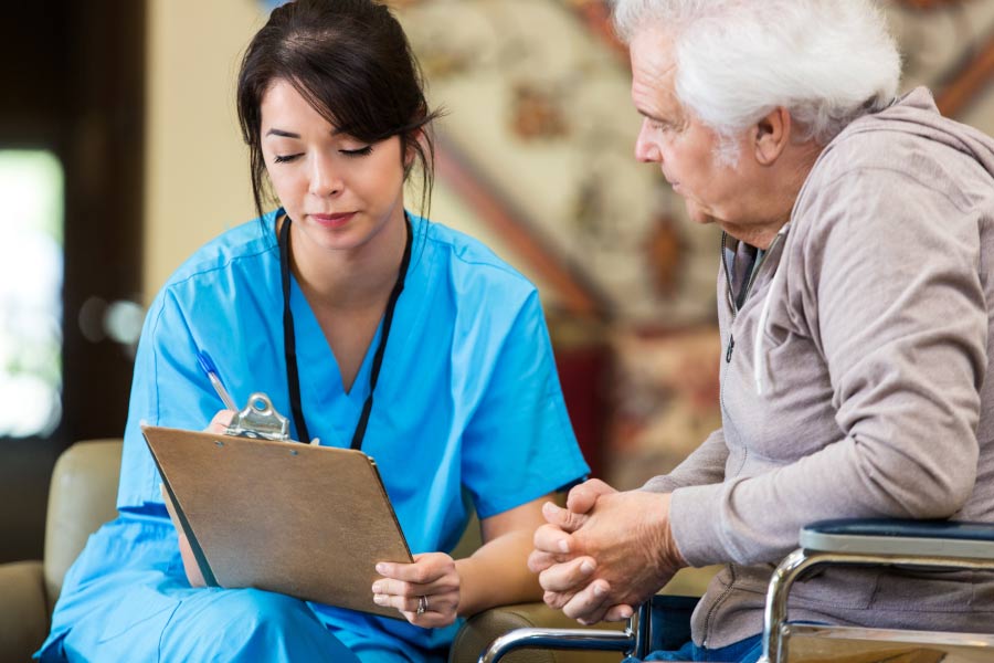 senior man consults with the dentist about chronic health issues and dental health